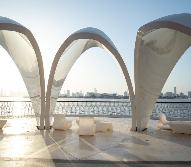Dubai Creek Harbour arches at sunset with city and Khalifa at the back